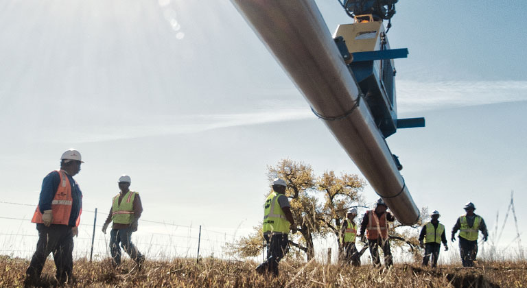 Xcel employees installing natural gas pipeline
